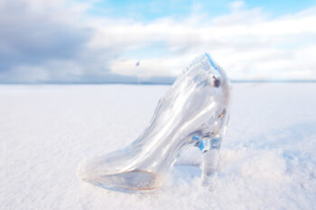 Glass high heeled shoe on snow