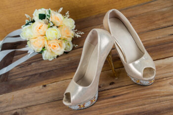 Ivory high heeled shoes and floral bouquet