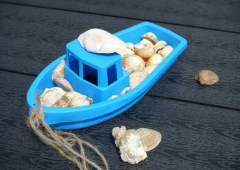 Blue toy boat with shells
