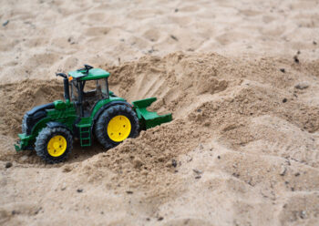 Toy tractor in the sand