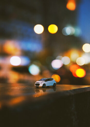 White toy car with illuminated background