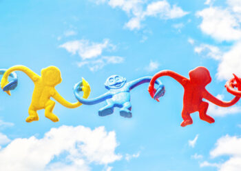 Coloured monkey toys with a sky background