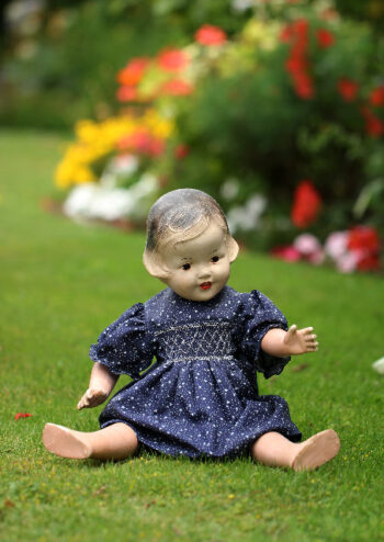 Doll sitting in garden