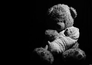 Teddy holding baby teddy black and white