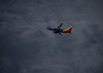 Multicoloured plane in flight
