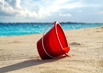 Red bucket on beach