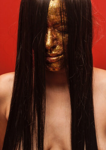 Female with gold glitter face