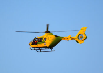 Yellow and green helicopter in flight