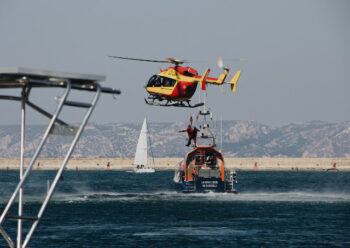 Rescue helicopter with winchman and rescue boat