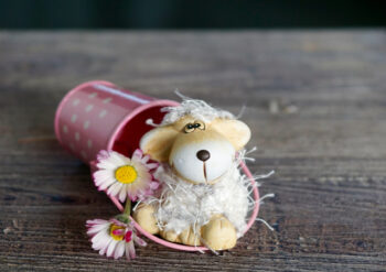 Lamb with pink bucket and flowers