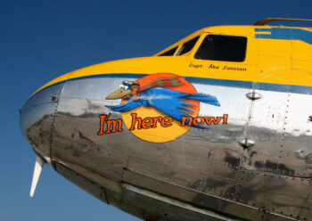 Nose of an old propeller plane with cartoon livery
