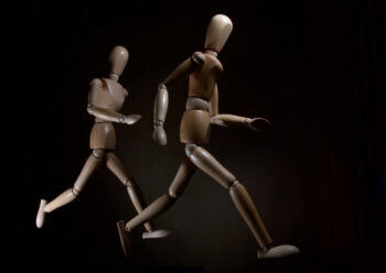 Wooden human figure characters with black background