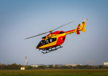 Low flying red and yellow helicopter