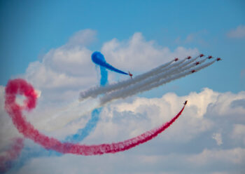 Red Arrows display team with red white and blue smoke