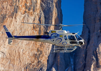 Helicopter flying near rock face