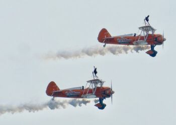 Two propeller display planes with wing walkers