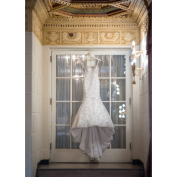 Wedding dress hanging in stately home