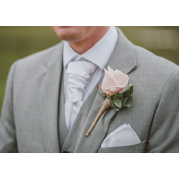 Groom wearing rose corsage